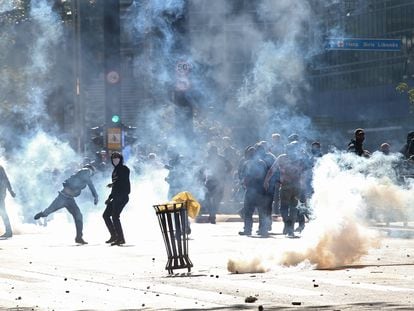 Manifestantes entre gás lacrimogênio na avenida Paulista.
