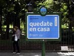 A woman walks near a board advertising Health Ministry advise reading "Stay at home" during the outbreak of the new Coronavirus, COVID-19, in Buenos Aires, Argentina on March 19, 2020. (Photo by JUAN MABROMATA / AFP)