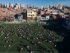 Residents gather on a soccer field as they wait to receive kits equipped with cleaning products and protective face masks for children provided by a non-governmental organization as a measure to help control the spread of the new coronavirus, in the Paraisopolis slum of Sao Paulo, Brazil, Wednesday, June 24, 2020. With over 100,000 residents, Paraisopolis is one of the areas of Sao Paulo that is most affected by COVID-19. (AP Photo/Andre Penner)