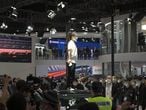 SHANGHAI, CHINA - APRIL 19: A woman stands atop a Tesla vehicle during the 19th Shanghai International Automobile Industry Exhibition (Auto Shanghai 2021) at National Exhibition and Convention Center (Shanghai) on April 19, 2021 in Shanghai, China. (Photo by VCG/VCG via Getty Images)