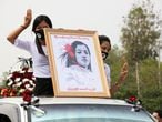 Women hold a portrait of Mya Thwate Thwate Khaing, a young woman protester who was shot in the head in Naypyitaw when police tried to disperse a crowd during protests against the military coup, at her funeral in Naypyitaw February 21, 2021. REUTERS/Stringer NO RESALES.NO ARCHIVES