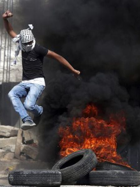Um homem enfrenta o Exército Israelense em Hebrón.