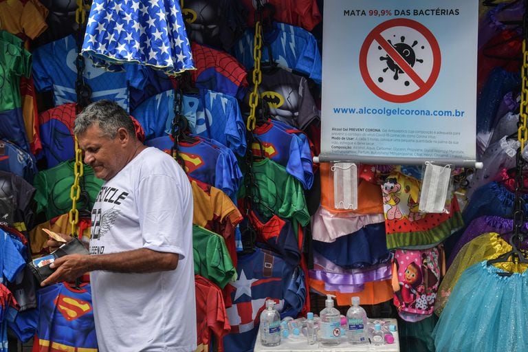 A street vendor sells hand sanitizer in downtown Sao Paulo, Brazil, on March 16, 2020. - The Sao Paulo stock exchange closed down 13.9 percent Monday and the Brazilian real closed below five to the dollar for the first time ever in further fallout from the coronavirus pandemic. (Photo by NELSON ALMEIDA / AFP)