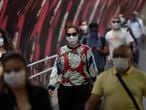 Commuters wear face masks inside the subway system amid the spread of the new coronavirus in Sao Paulo, Brazil, Monday, May 4, 2020. The state government mandated that commuters using public transportation must wear face masks starting Monday. (AP Photo/Andre Penner)
