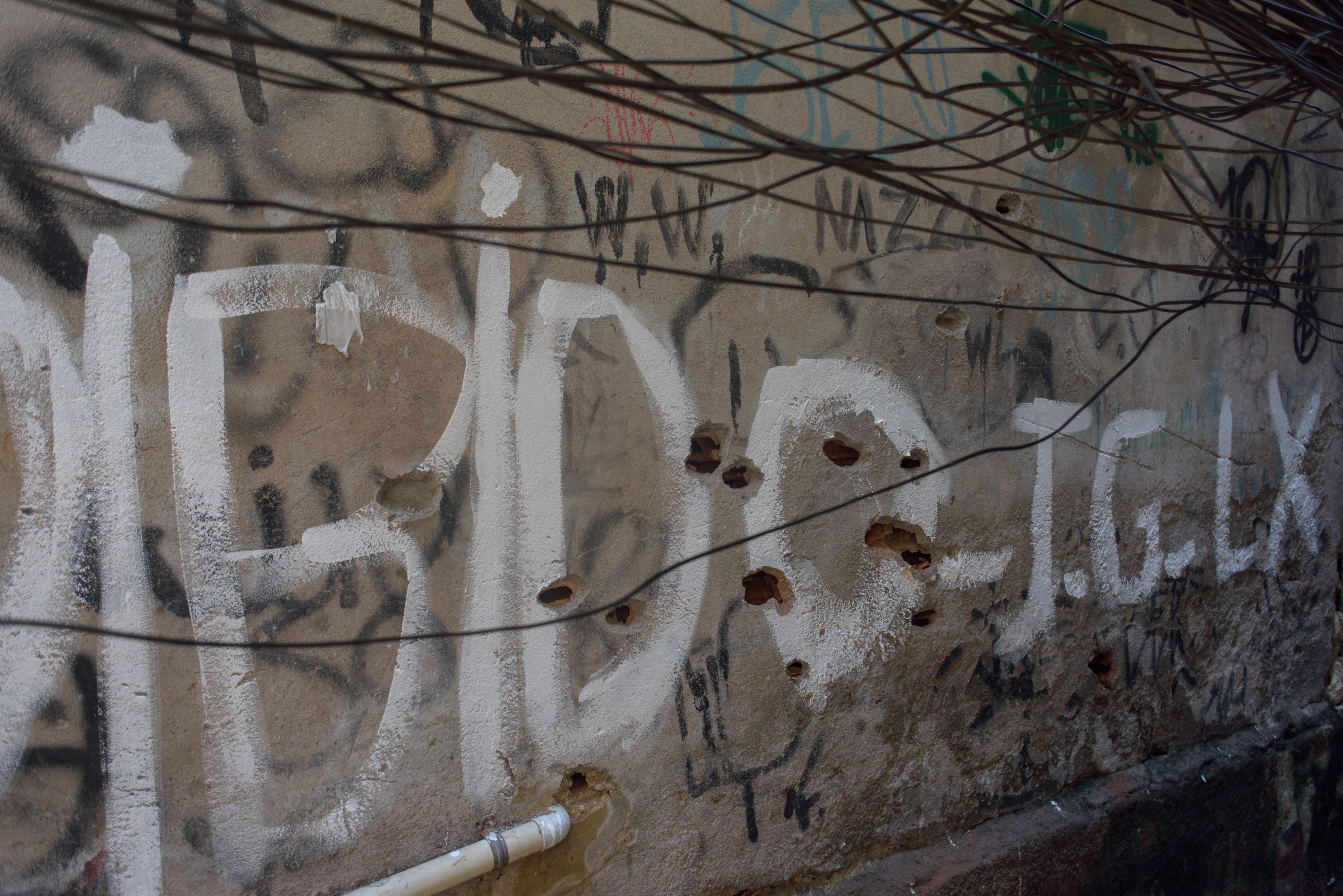 Buracos de bala em uma parede da favela. 
