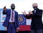 U.S. President-elect Joe Biden points to Democratic U.S. Senate candidates from Georgia Jon Ossoff  and Raphael Warnock, as he campaigns on their behalf ahead of their January 5 run-off elections, during a drive-in campaign rally in Atlanta, Georgia, U.S., January 4, 2021. REUTERS/Jonathan Ernst