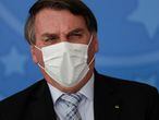 Brazil's President Jair Bolsonaro reacts during a ceremony to expand the ability of the government to purchase vaccines against COVID-19, amid the coronavirus disease (COVID-19) outbreak, in Brasilia, Brazil, March 10, 2021. REUTERS/Ueslei Marcelino