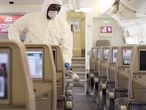 A handout image provided by Emirates airlines on March 8, 2020 in Dubai shows a member of the cleaning staff spraying disinfectant aboard an Emirates Airbus A380-800 aircraft for sterilisation efforts amidst efforts against COVID-19 coronavirus disease. (Photo by - / Emirates Airlines / AFP) / === RESTRICTED TO EDITORIAL USE - MANDATORY CREDIT "AFP PHOTO / HO / EMIRATES" - NO MARKETING NO ADVERTISING CAMPAIGNS - DISTRIBUTED AS A SERVICE TO CLIENTS ===