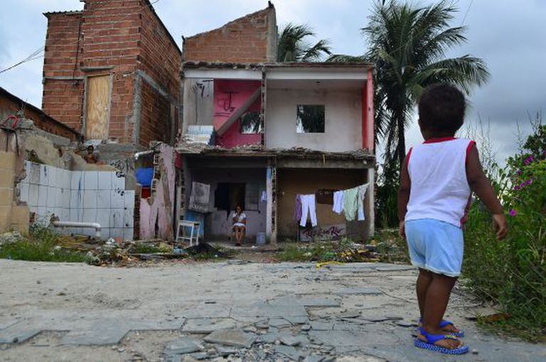 Uma criança observa os escombros de uma casa na Vila Autódromo, em março deste ano.