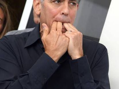 George Clooney assobia no posado ante os fotógrafos em Veneza.