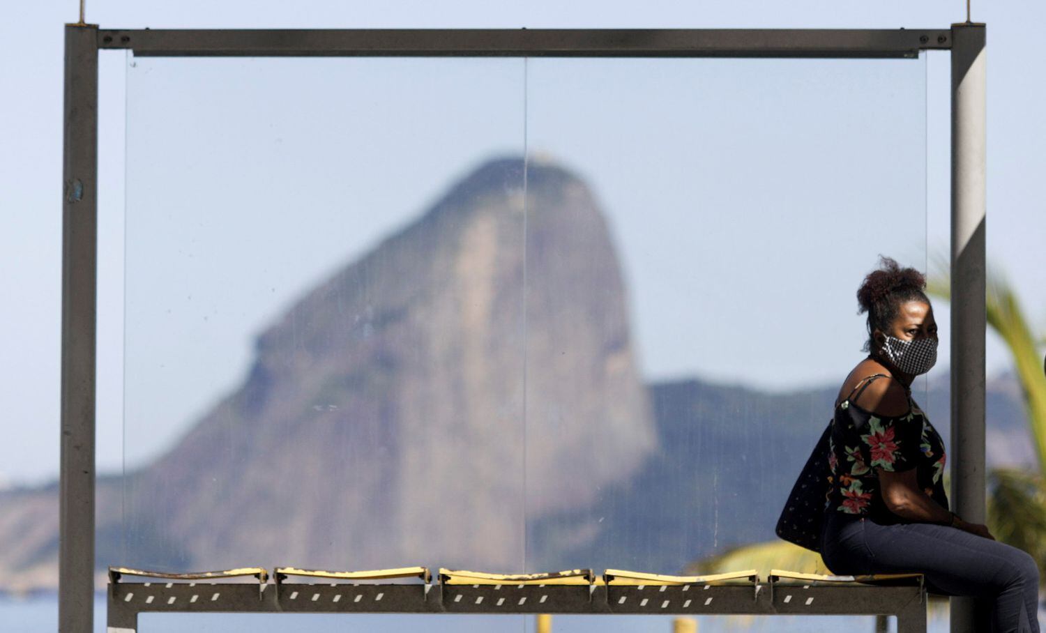 Mulher usa máscara em um ponto de ônibus no Rio de Janeiro na última segunda-feira.