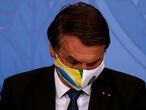 Brazil's President Jair Bolsonaro reacts during a ceremony of release of resources for Primary Health Care in combat of the coronavirus disease (COVID-19), at the Planalto Palace in Brasilia, Brazil May 11, 2021. REUTERS/Ueslei Marcelino
