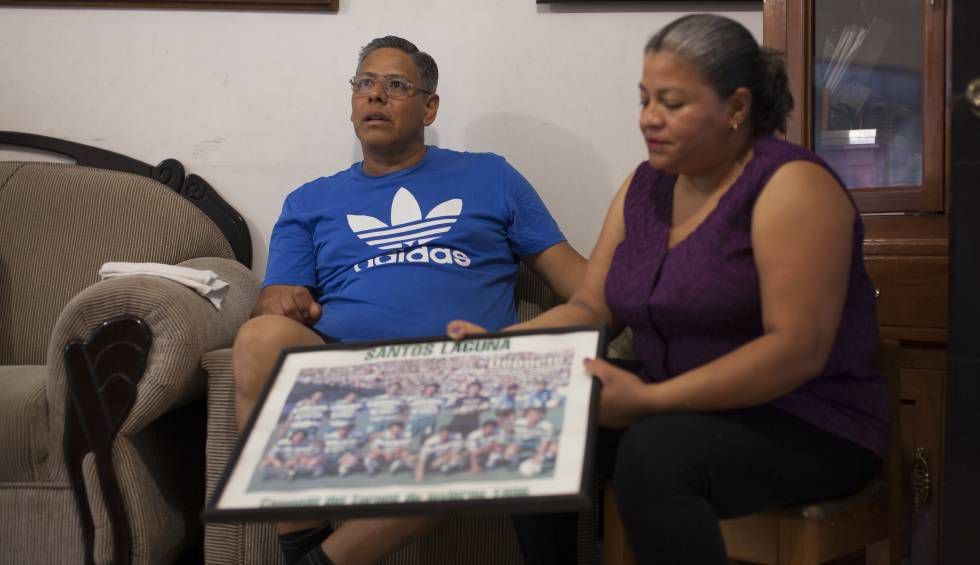 Os pais de Cisneros, Mario e Olga, seguram uma foto do elenco do Santos Laguna.