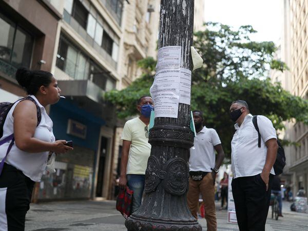 People look at job listings posted on a light pole in downtown Sao Paulo, Brazil, October 6, 2020. Picture taken October 6, 2020. REUTERS/Amanda Perobelli