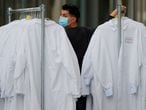 FILE PHOTO: A worker delivers protective lab coats to the headquarters of Moderna Therapeutics, which is developing a vaccine against the coronavirus disease (COVID-19), in Cambridge, Massachusetts, U.S., May 18, 2020./File Photo