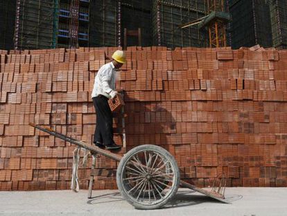 Um operário empilha tijolos na cidade chinesa de Hangzhou.