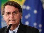 FILE PHOTO: Brazil's President Jair Bolsonaro reacts during a ceremony to expand the ability of the government to purchase vaccines against COVID-19, amid the coronavirus disease (COVID-19) outbreak, in Brasilia, Brazil, March 10, 2021. REUTERS/Ueslei Marcelino/File Photo/File Photo