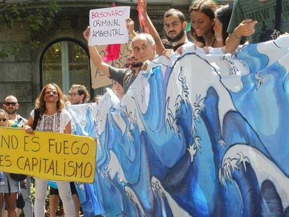 Manifestantes protestam em frente ao consulado brasileiro em Barcelona, na Espanha, nesta sexta-feira contra incêndios florestais no Brasil.