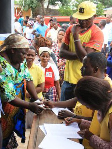 Uma eleitora apresenta sua documentação em um posto de votação em Maputo, nesta quarta-feira.