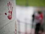 In this Thursday, June 18, 2020 photo, a small group of protestors placed painted red hands on the Ohio Statehouse, to signify the blood on police hands, they said during a demonstration in Columbus, Ohio. (Courtney Hergesheimer/The Columbus Dispatch via AP)