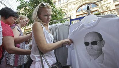 Uma mulher em Moscou observa uma camiseta com a fotografia do presidente russo.