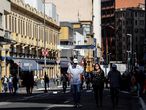 AME3585. SAO PAULO (BRASIL), 01/06/2020.- Personas con tapabocas caminan frente a tiendas cerradas por la situación del coronavirus, este lunes, en la ciudad de Sao Paulo (Brasil). Varias ciudades de los estados brasileños de Sao Paulo, Ceará, Amazonas y Pará, cuatro de los más azotados por la crisis de coronavirus, iniciaron este lunes la reapertura gradual de sus economías, pese a la todavía creciente expansión de la enfermedad. Sao Paulo, la región más industrializada y rica del país, comenzó hoy una desescalada por fases aún no materializada en la capital homónima y su zona metropolitana, que concentran prácticamente la mitad de sus 46 millones de habitantes. En número absolutos, Sao Paulo, donde rige una cuarentena "blanda" desde finales de marzo, es el estado de Brasil más afectado por la pandemia, con 7.615 muertes y 109.698 casos confirmados de COVID-19, según el último boletín del Ministerio de Salud. EFE/ Sebastião Moreira