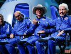 FILE PHOTO: Billionaire American businessman Jeff Bezos (3rd-L) shakes hands with Wally Funk, who became the oldest person in space with other crew mates Oliver Daemen (L) and Mark Bezos (2nd-L) at a post-launch press conference after they flew on Blue Origin's inaugural flight to the edge of space, in the nearby town of Van Horn, Texas, U.S. July 20, 2021.   REUTERS/Joe Skipper/File Photo