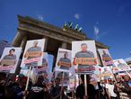 Berlin (Germany), 29/08/2020.- Demonstrators hold pictures of responsible persons in front of Brandenburg Gate, during a protest against coronavirus pandemic regulations in Berlin, Germany, 29 August 2020. The initiative 'Querdenken 711' and an alliance of right wing groups have called to demonstrate against coronavirus regulations like face mask wearing, in Berlin. Meanwhile forbidden, Berlin administrative court and higher administrative court allowed the demonstration to take place under certain requirements. Police announced to stop the demonstration when conditions were not met. (Protestas, Alemania) EFE/EPA/CLEMENS BILAN