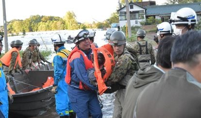 Equipes de resgate retiram moradores de área afetada pelo tufão em Kawagoe.