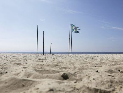Bandeira brasileira na praia de Copacabana, fechada por causa da crise sanitária.