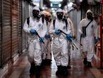 Soldiers from the 4th Military Region of the Brazilian Armed Forces take part in the cleaning and disinfection of the Municipal Market in the Belo Horizonte, state of Minas Gerais, Brazil on August 18, 2020, amid the COVID-19 coronavirus pandemic. (Photo by DOUGLAS MAGNO / AFP)