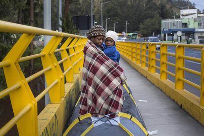 Mãe com o filho na ponte da fronteira