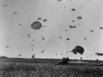 Paraquedistas aliados pousam na Normandia durante o Dia D.
