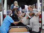 Healthcare workers and relatives carry Shashikantbhai Parekh, a patient with breathing problem, out from an ambulance for treatment at a COVID-19 hospital, amidst the spread of the coronavirus disease (COVID-19) in Ahmedabad, India, April 28, 2021. REUTERS/Amit Dave