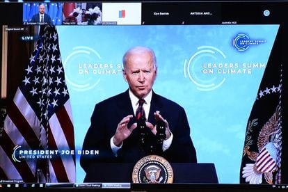 US President Joe Biden is seen on the screen as he attends the leaders summit on climate via video conference, in Brussels on April 22, 2021. (Photo by JOHANNA GERON / POOL / AFP)