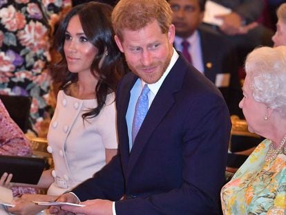 Elizabeth II, o príncipe Harry e Meghan Markle, em uma cerimônia de entrega de prêmios no palácio de Buckingham, em junho de 2018.