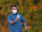 Brazil's President Jair Bolsonaro holds a box of chloroquine outside of the Alvorada Palace, amid the coronavirus disease (COVID-19) outbreak in Brasilia, Brazil, July 23, 2020.REUTERS/Adriano Machado     TPX IMAGES OF THE DAY
