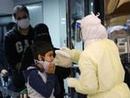 Passengers coming from China wearing masks to prevent a new coronavirus are checked by Saudi Health Ministry employees upon their arrival at King Khalid International Airport, in Riyadh, Saudi Arabia January 29, 2020. REUTERS/Ahmed Yosri