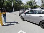 A television crew interviews a driver in line at a drive-through COVID-19 testing site, Friday, March 20, 2020, at the Doris Ison Health Center in Miami. (AP Photo/Wilfredo Lee)