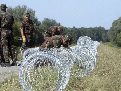 Soldados do Exército húngaro continuam construindo a cerca na fronteira com a Croácia, em 18 de setembro de 2015.