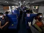 Passengers on a train with staggered seating wear face masks to curb the spread of the coronavirus at the Hua Lamphong Railway Station in Bangkok, Thailand, Tuesday, June 9, 2020. The Thai government continues to ease restrictions related to running business in capital Bangkok that were imposed weeks ago to combat the spread of COVID-19. (AP Photo/Sakchai Lalit)