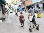People walk with plastic containers near an unknown water source in the low-income neighbourhood of Petare amid the coronavirus disease (COVID-19) outbreak in Caracas, Venezuela June 3, 2020. Picture taken June 3, 2020. REUTERS/Manaure Quintero