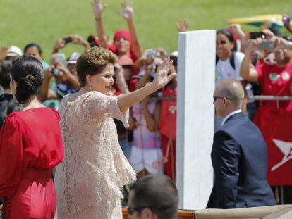 Dilma acena para militantes ao lado da filha.