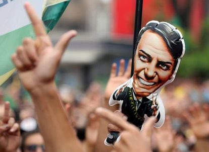 Apoiadores de Jair Bolsonaro fazem gesto de arma com as mãos em manifestação de apoio ao presidente, em julho de 2019.