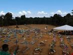 New graves fill the the Nossa Senhora Aparecida cemetery, in Manaus, Amazonas state, Brazil, Tuesday, April 21, 2020. The cemetery is carrying out burials in common graves due to the large number of deaths from COVID-19 disease, according to a cemetery official. (AP Photo/Edmar Barros)