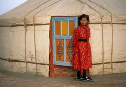 Menina sai de uma iurta, tenda tradicional dos nômades da Mongólia.