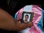 A member of the LGBTIQ+ community places a portrait of Andrea Gonzalez on her coffin, before her burial in Guatemala City, on June 13, 2021. - The activist and LGBTIQ+ leader was shot to death in the Guatemalan capital, which provoked repudiation and indignation in different national and international sectors. (Photo by Johan ORDONEZ / AFP)