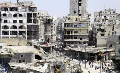 Um grupo de civis chega às ruínas de Homs no sábado passado depois da evacuação dos rebeldes.