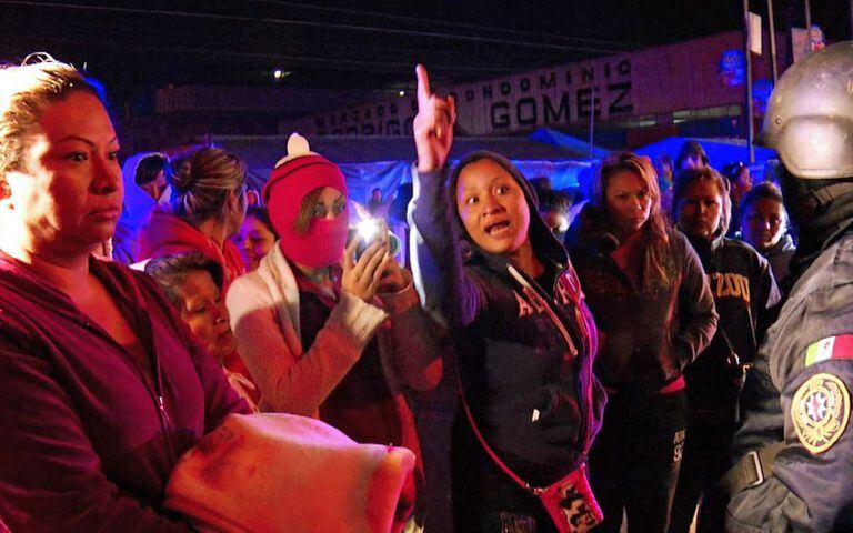 Family members of inmates stand outside Topo Chico prison following the riot.
