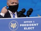 President-elect Joe Biden removes his mask as he arrives to speak after the Electoral College formally elected him as president, Monday, Dec. 14, 2020, at The Queen theater in Wilmington, Del. (AP Photo/Patrick Semansky)